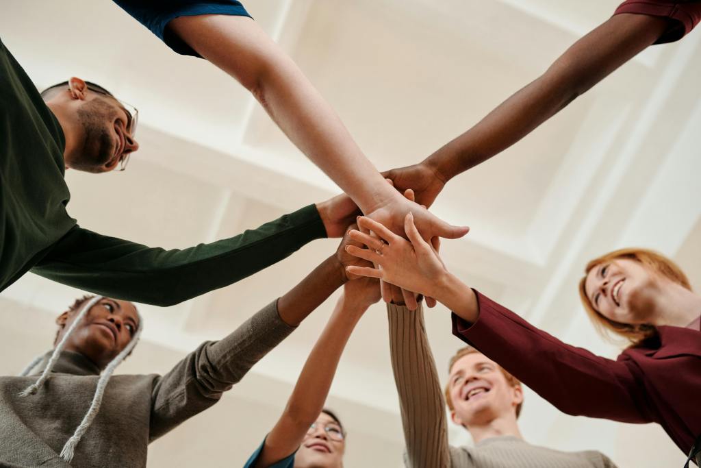 7 arms and hands showing the power of team